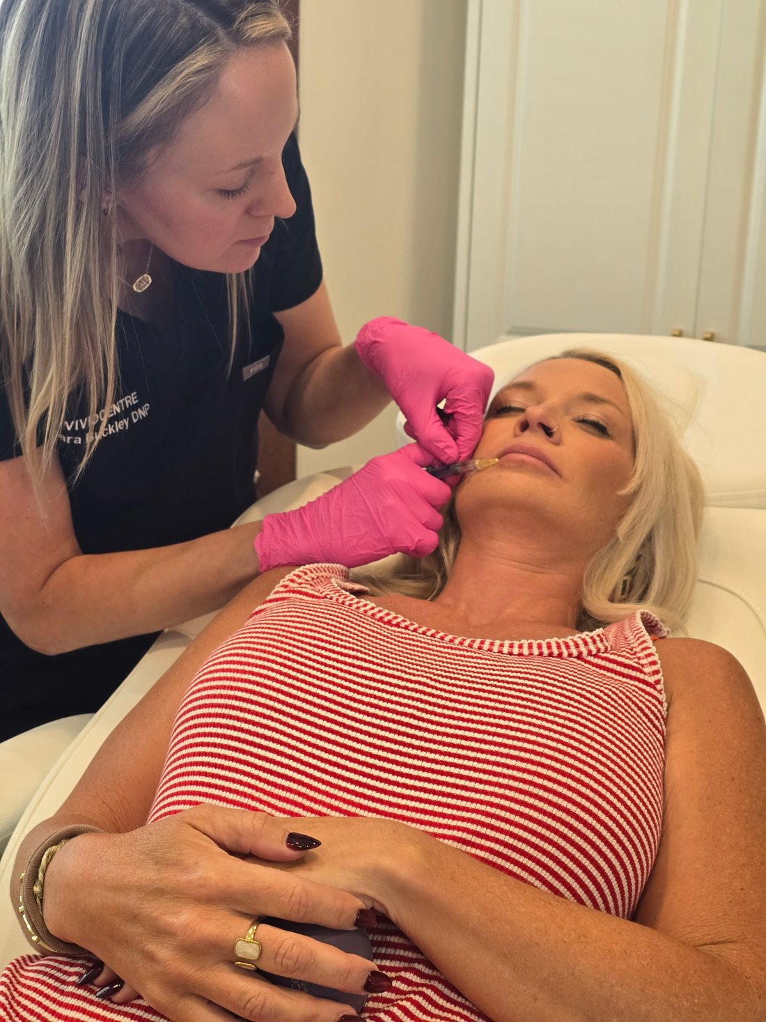 Sara Buckley performing precise lip filler treatment